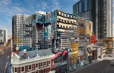 An RMIT University campus building, its patterned facade rising above an older street frontage