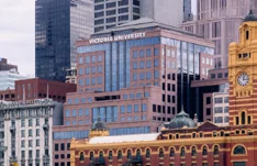 The Victoria University building in Melbourne among the surrounding city buildings